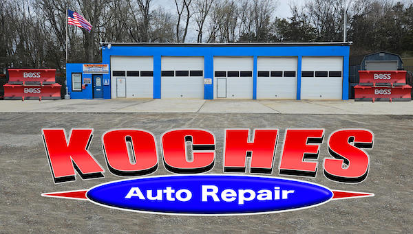 Koches car repair shop with a tow truck and Boss snowplows.